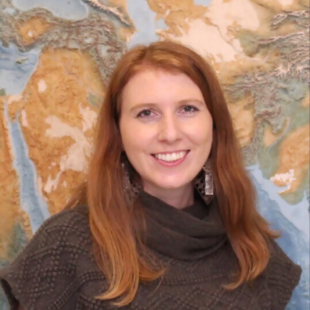 headshot of a white woman with long red hair